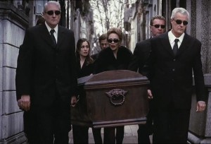 The guy in front doesn't even realise he's carrying a coffin